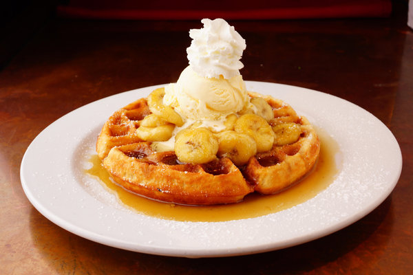 Martinique waffle with bananas flambeed in dark rum, vanilla ice cream and whipped cream