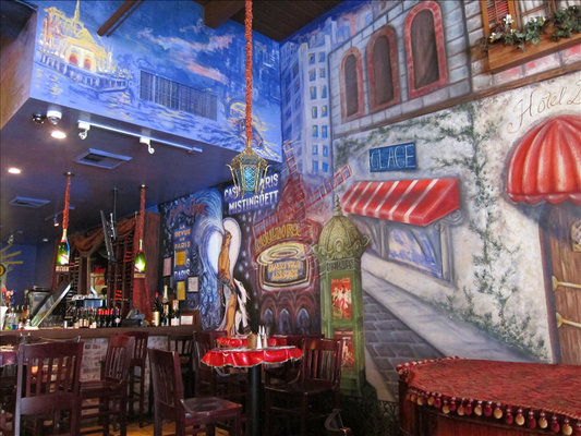 Hand painted Paris street mural beside the bar at La Creperie Cafe