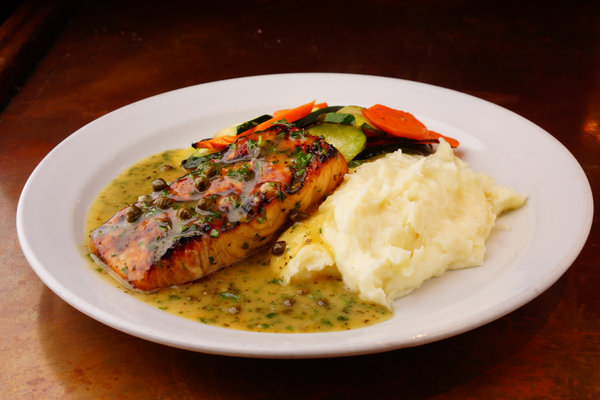 Saumon Filet with lemon caper butter sauce, mashed potatoes and sauteed vegetables